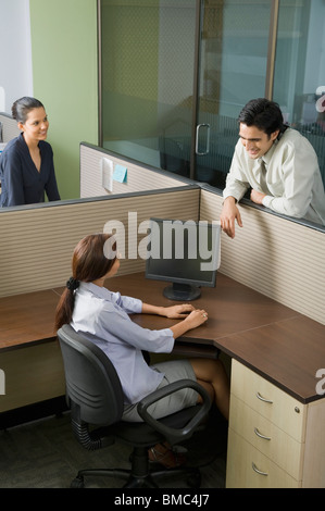 Three business executives talking in an office Stock Photo