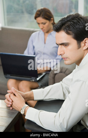 Business executives sitting in a waiting room Stock Photo