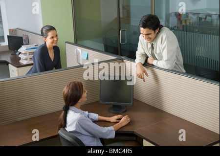 Three business executives talking in an office Stock Photo