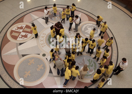 School children looking at seals on floor of Texas state capitol building rotunda in Austin Stock Photo