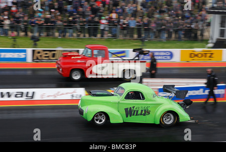 Super Gas drag racing at Santa Pod, driven by Jon Giles (Ford Willys Coupe) nearside Paul Foote (Ford F100) far side. Stock Photo