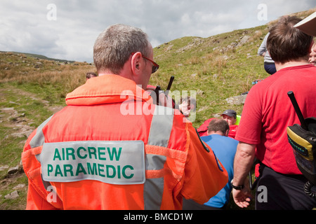 A man with a leg injury is stretchered by members of the Langdale/Ambleside Mountain Rescue Team, above Grasmere, Lake District, Stock Photo