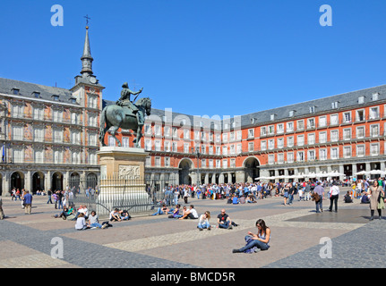 Madrid, Spain. Plaza Mayor. Young people sitting in the sun Stock Photo