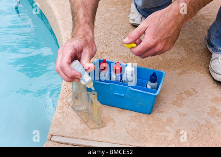 Man checking the ph level of a swimming pool. Stock Photo