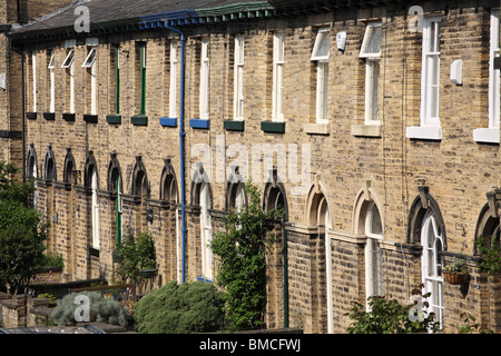 A row of terraced houses in Sir Titus Salt's model village Saltaire, near Bradford, West Yorkshire, England, UK Stock Photo