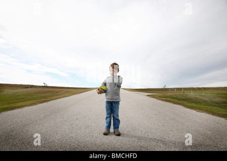 Boy Standing on Road Stock Photo