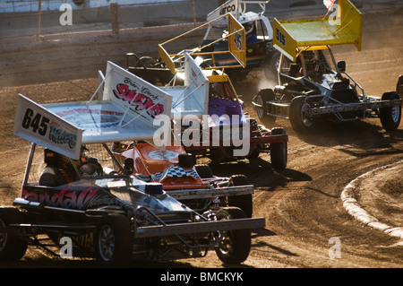 formula 2 stock cars corner on an oval race track Stock Photo