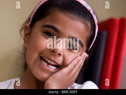 Smiling cute little girl showing gap created by first missing baby tooth from her deciduous band of teeth. Stock Photo