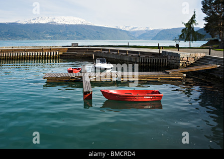 Small Harbour in Sognefjord in Balestrand near Kviknes Hotel Sogn Norway with re and white boats Stock Photo