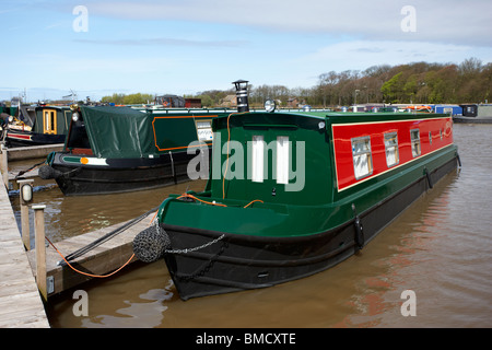 traditional english narrow and wide canal boats moored at scarisbrick marina near fettlers wharf marina liverpool leeds canal Stock Photo