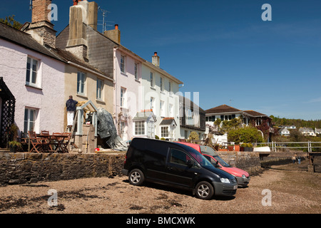 UK, England, Devon, Dittisham, colourfully painted riverside houses on the Quay being maintained by builder Stock Photo