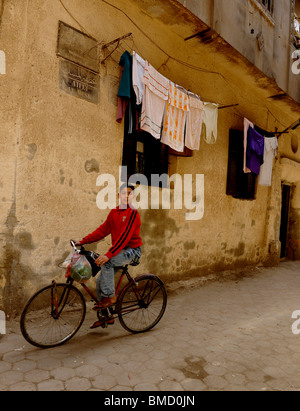 young boy  riding his bicycle , back streets of  Al Ghuriyya(al ghariya), Islamic Cairo, Cairo, Egypt Stock Photo