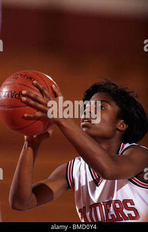 Female High School basketball player in action shooting a free throw during a game. Stock Photo