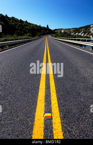 A view down the middle of State Highway 10 between Napier and Wairoa where it passes over the Mohaka River, New Zealand Stock Photo