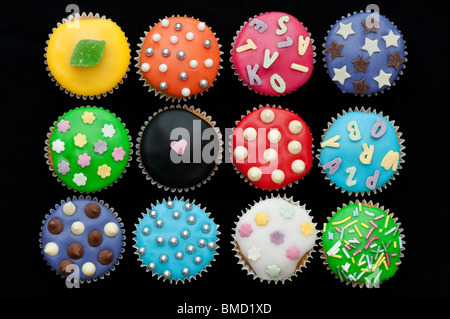 Colourful mini cupcakes on a black background Stock Photo