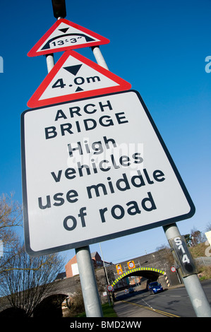 Road sign warning of a low bridge in a market town in England. Stock Photo