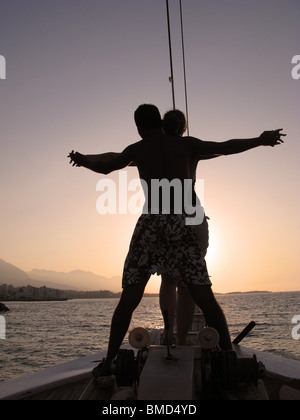 A young couple sailing into the setting sun on a Turkish gulet. North Cyprus, 2009. Stock Photo