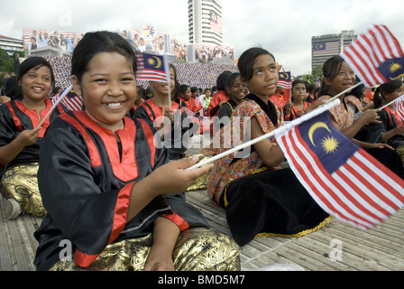 Young performers waving the Malaysian flag, Merdeka Square, Kuala Lumpur, Malaysia Stock Photo