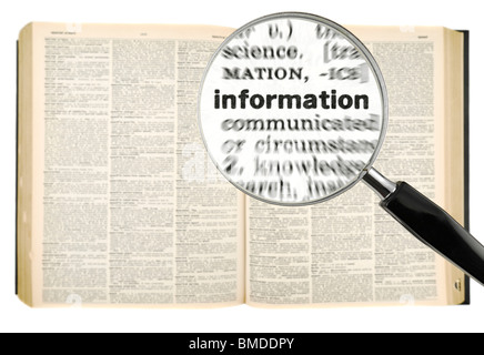 A magnifying glass on the word INFORMATION on a dictionary. Isolated on white. Stock Photo