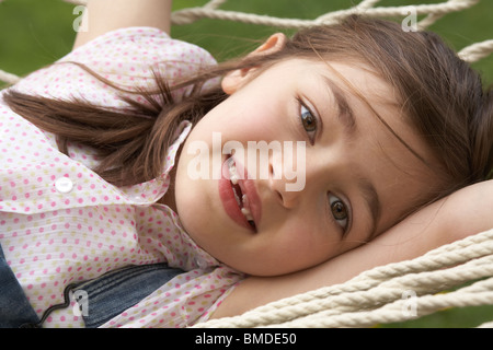 Young girl laying in hammock Stock Photo