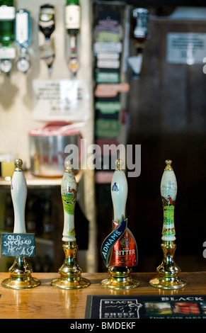 Beer pump handles in a traditional pub in Essex.  Photo by Gordon Scammell Stock Photo