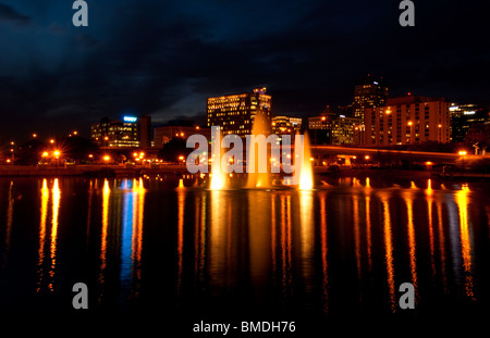 Orlando Florida Skyline at night taken from Lake Lucerne looking north with beautiful fountains lit in the evening Stock Photo