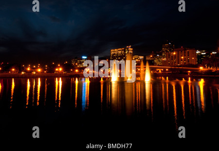 Orlando Florida Skyline at night taken from Lake Lucerne looking north with beautiful fountains lit in the evening Stock Photo