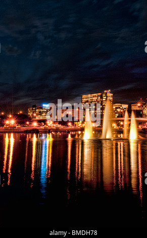 Orlando Florida Skyline at night taken from Lake Lucerne looking north with beautiful fountains lit in the evening Stock Photo