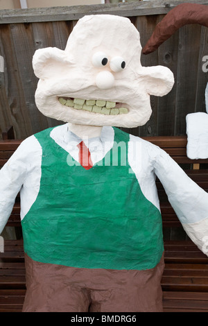 Wallace sat on bench at Bisterne Annual Scarecrow Festival, Bisterne, New Forest National Park, Hampshire, UK in September Stock Photo