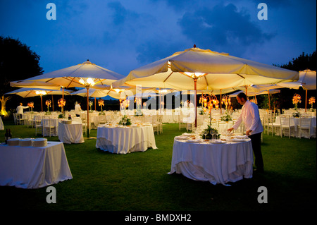 Outdoor wedding dinner table arrangement at night Stock Photo