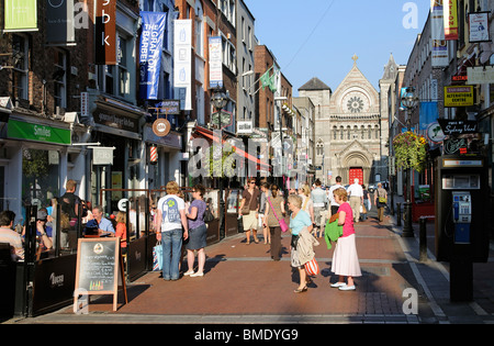 City centre Dublin Ireland pedestrians on Anne Street South in the Grafton St district with a backdrop of the Anglican St Anns c Stock Photo