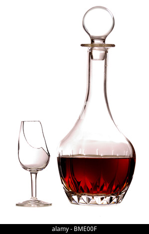 A decanter of sherry and an empty broken glass, isolated on a pure white background. Stock Photo