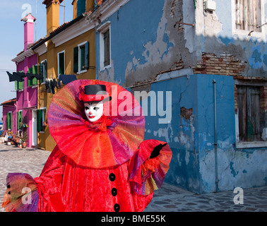 Clown walking the streets of Burano, Italy during the Venice Carnival Stock Photo