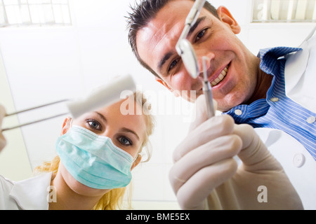 dentist and assistant working on patient Stock Photo