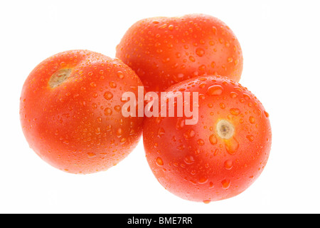 Three ripe tomatoes with dew isolated on white Stock Photo