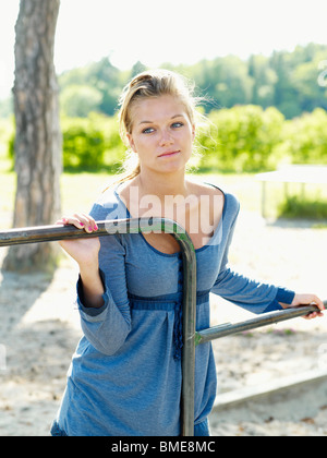 Young woman standing isolated on grey wall chatting with friend on ...