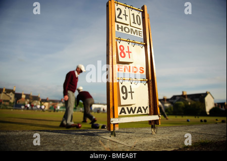 Men playing a game of lawn green bowls on a summer evening, Aberystwyth Wales UK Stock Photo