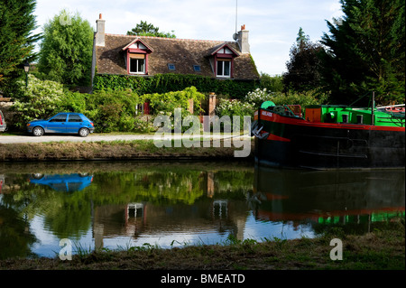 Reflection of house and car in pond Stock Photo