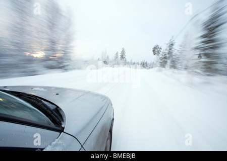 Car moving on snow covered road Stock Photo