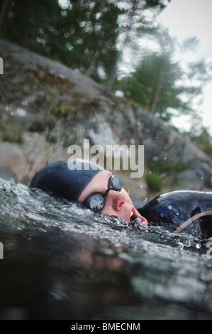 Woman swimming, close-up Stock Photo