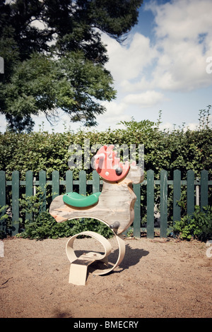 Old rocking horse in playground Stock Photo