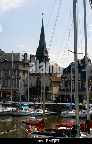 The harbour area at Honfleur in Northern France, with the church of St Etienne in the background Stock Photo