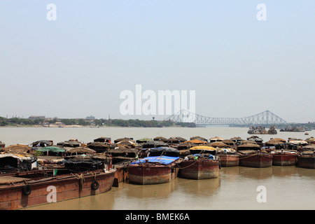 Boats on the Hooghly River, Calcutta, with the Howrah Bridge in the background. Stock Photo