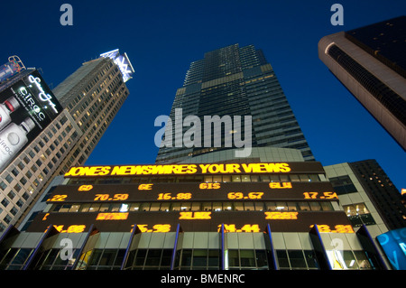 Giant ticker tape LED displays in TImes Square display breaking news stories and world stock market numbers, New York CIty, NY. Stock Photo