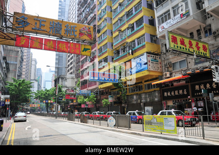 Urban view of Chinese hoardings and parked taxis at the western end of Lockhart Road, looking west, Wan Chai, Hong Kong, China Stock Photo