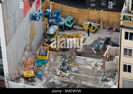 View of a demolition site and beginning of a new building with bulldozers. Munich, Germany Stock Photo
