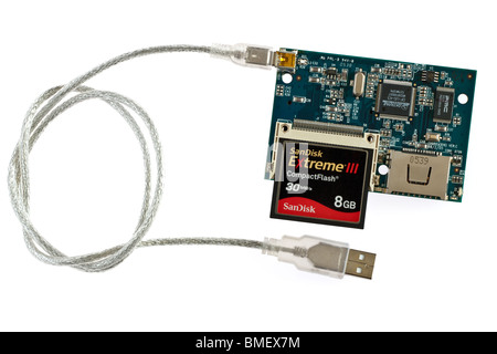 Inner pcb board workings and a Sandisk 8 GB Extreme 3 compact flash card on a multi card reader with Usb 2 to mini USB cable. Stock Photo