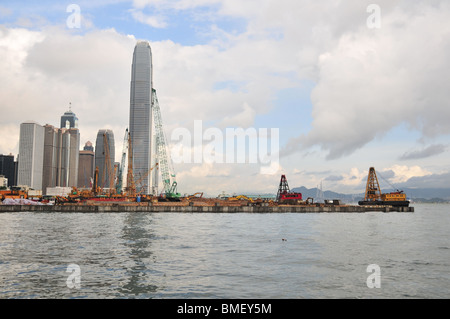 Land Reclamation, viewed from the Wan Chai Waterfront, extending into Victoria Harbour, in front of IFC2 and Central, Hong Kong Stock Photo