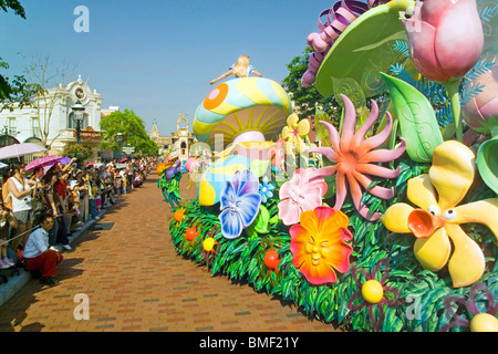 Tourists watching colorful floats during parade, Fantasyland, Hong Kong Disneyland, Lantau Island, Hong Kong, China Stock Photo