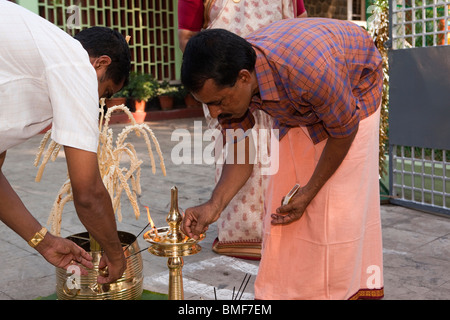 India, Kerala, Kochi, Ernakulam Uthsavom festival, men preparing household Para and temple oil lamps ready for puja Stock Photo